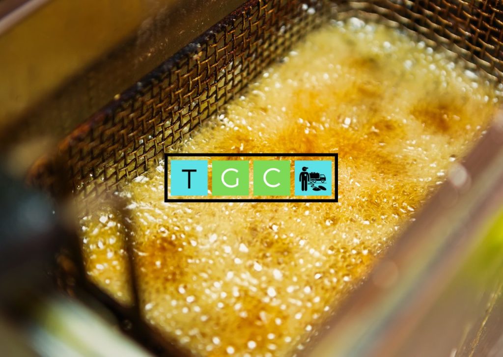 Commercial deep fryer containing used cooking oil in a restaurant kitchen